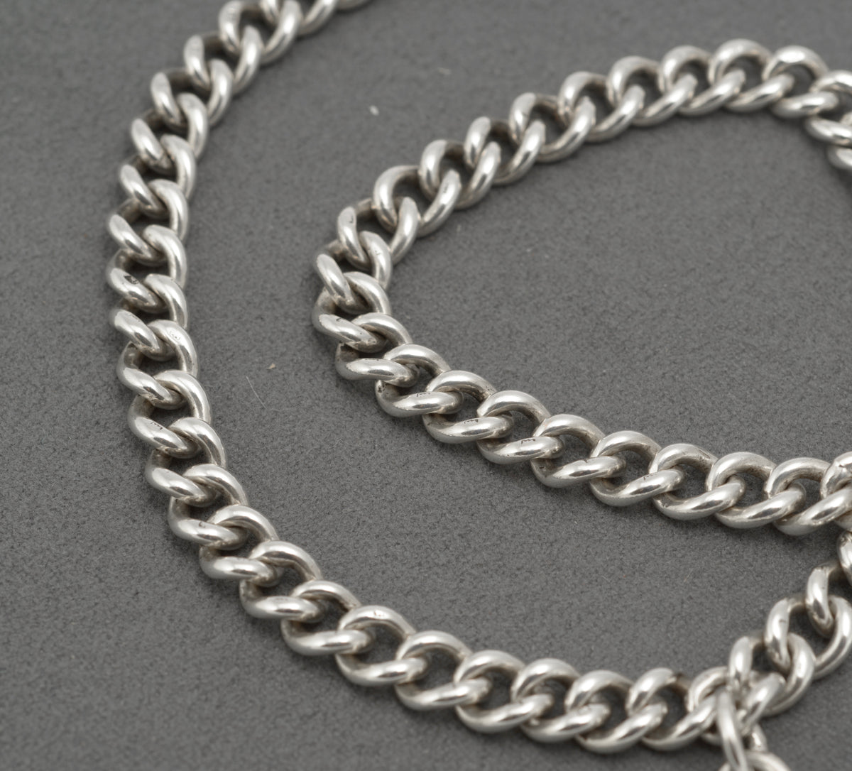 Antique sterling silver double Albert watch chain photographed on a white background