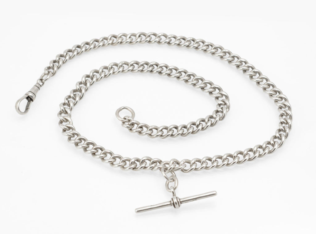 Close view of the terminal jump ring and hallmarked curb links on an antique sterling silver Albert chain