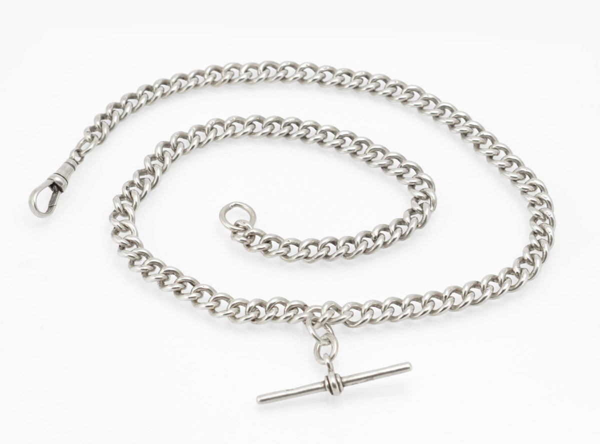 Close view of the terminal jump ring and hallmarked curb links on an antique sterling silver Albert chain