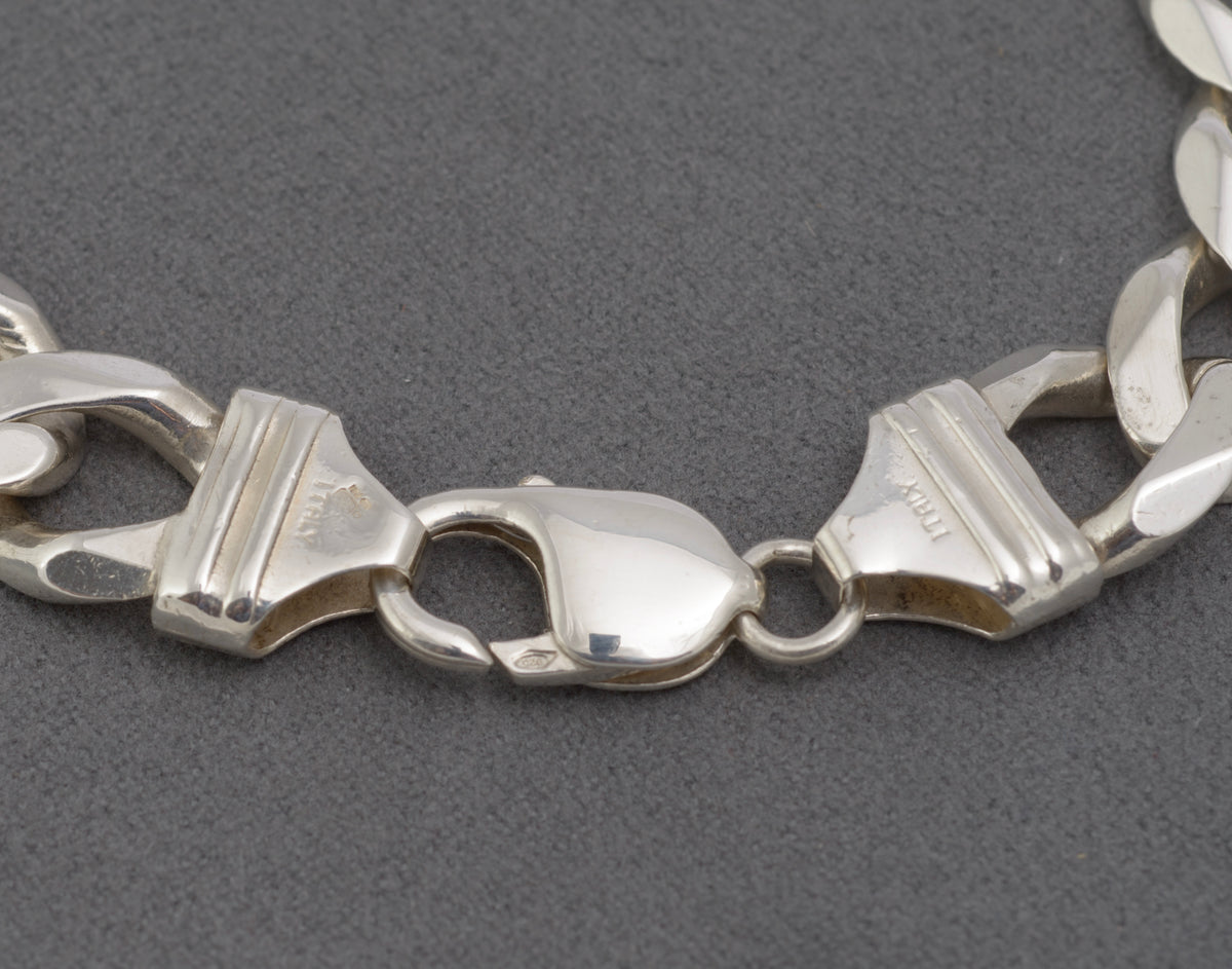 Italian sterling silver flat curb link bracelet, detailed view of interlocking polished links