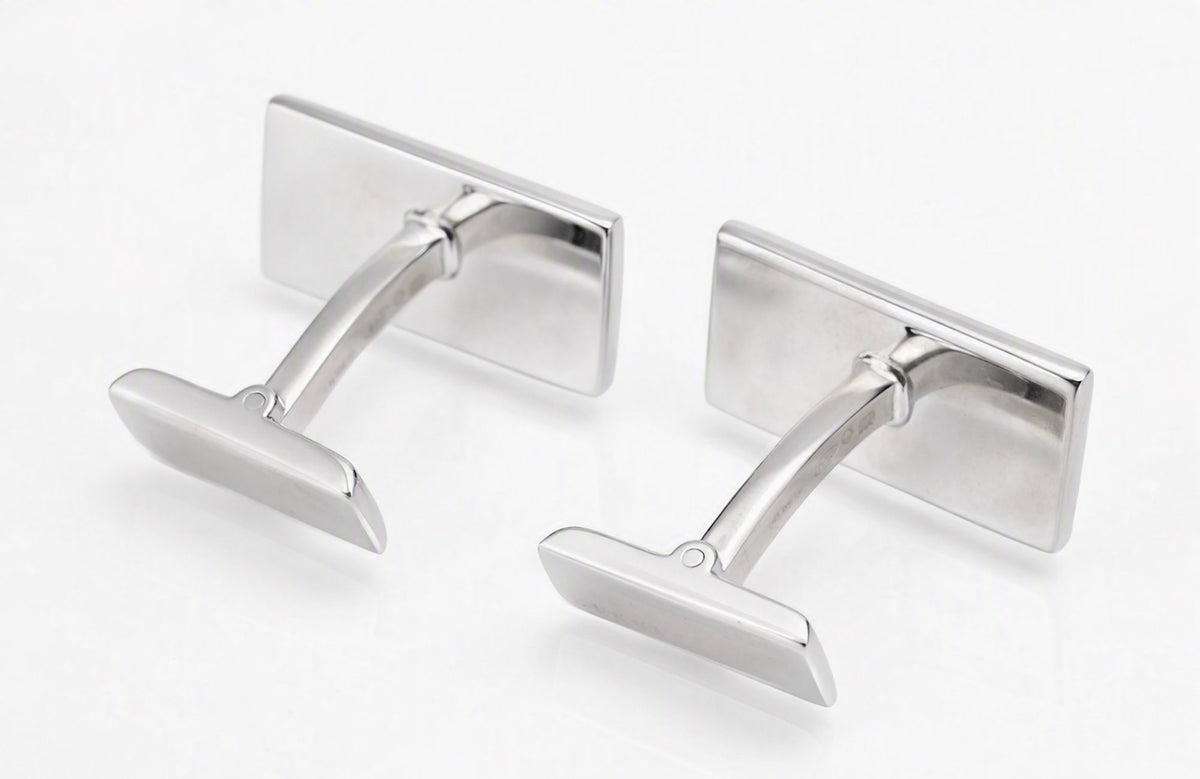 Close view of a vintage Gucci sterling silver cufflink showing the rectangular head and toggle fitting