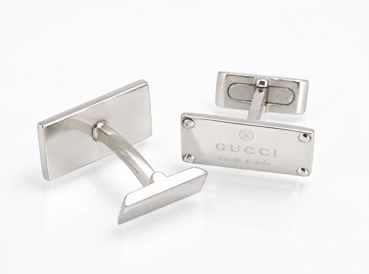 Vintage Gucci sterling silver cufflinks showing the engraved rectangular heads and articulated toggle backs