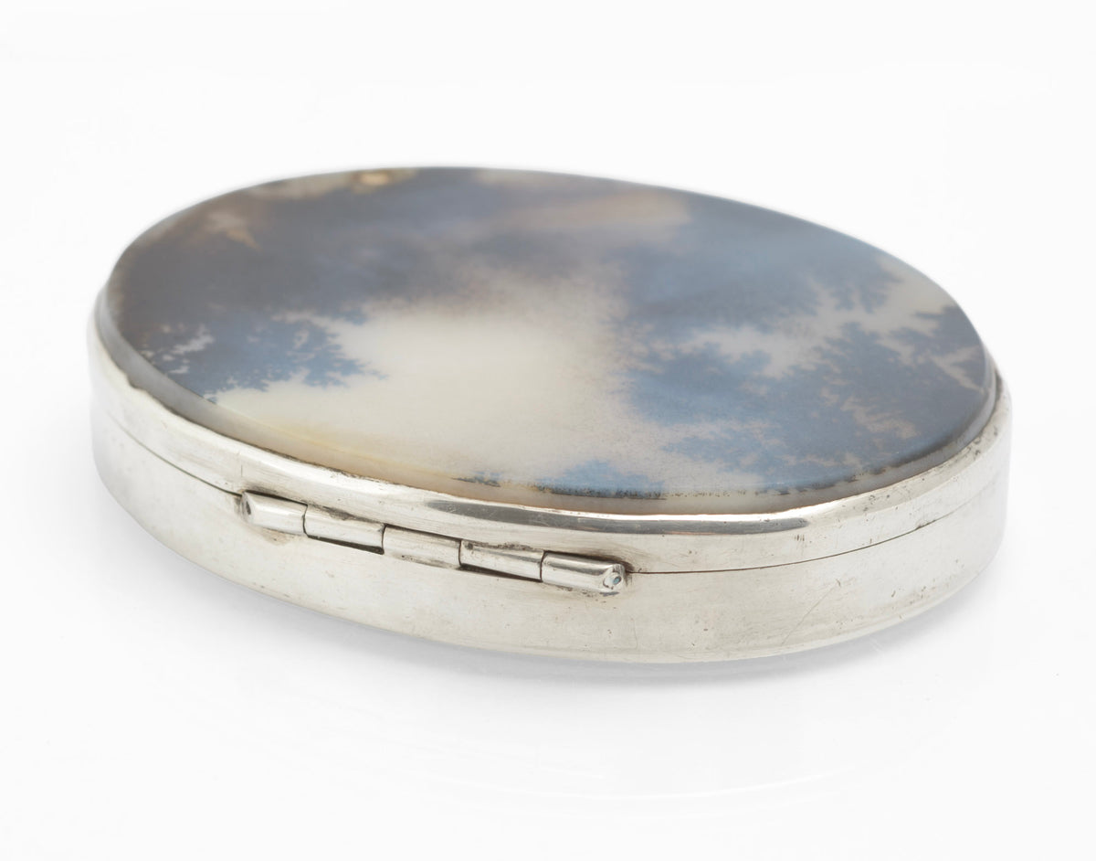 Close view of the natural moss agate cabochon lid on an antique sterling silver oval box