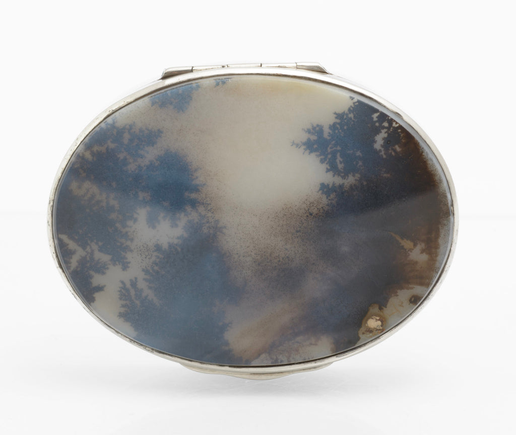 Antique sterling silver oval box shown closed from above with the natural moss agate cabochon visible
