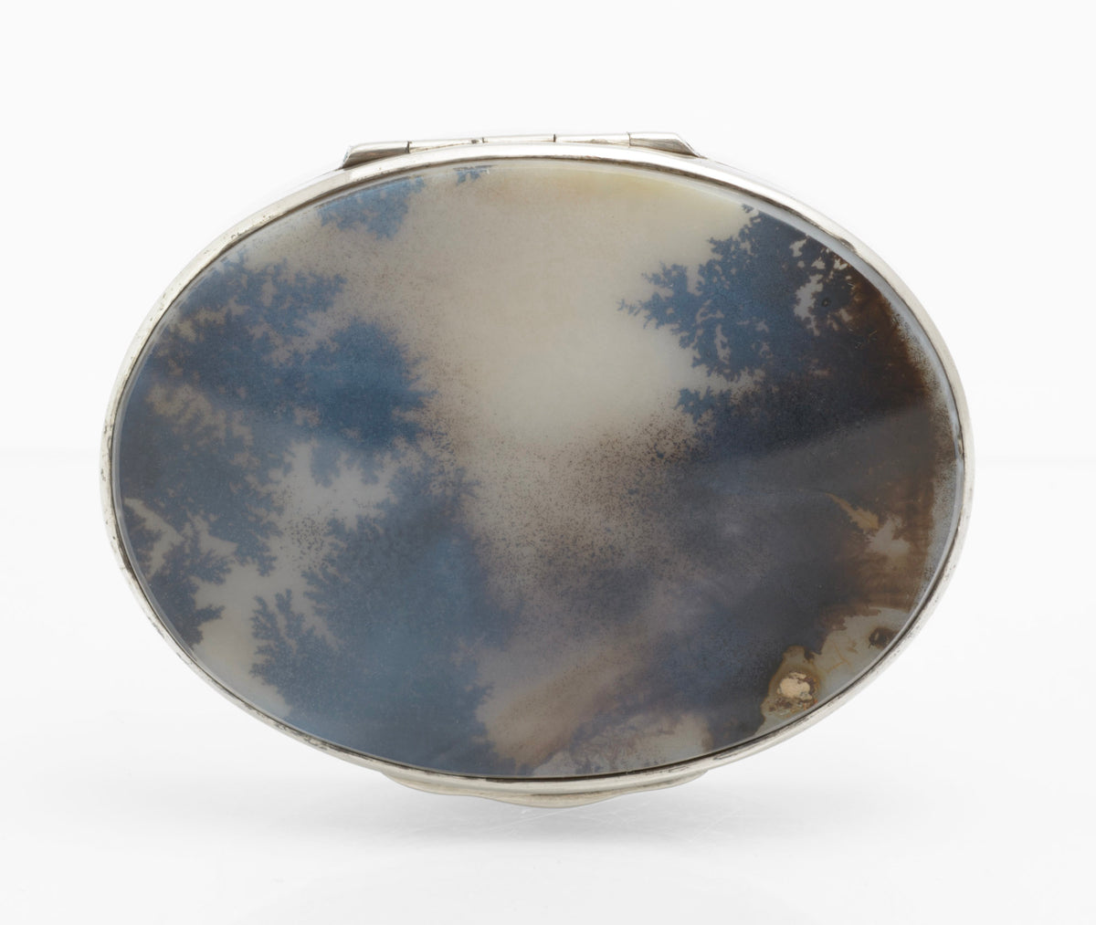 Antique sterling silver oval box shown closed from above with the natural moss agate cabochon visible