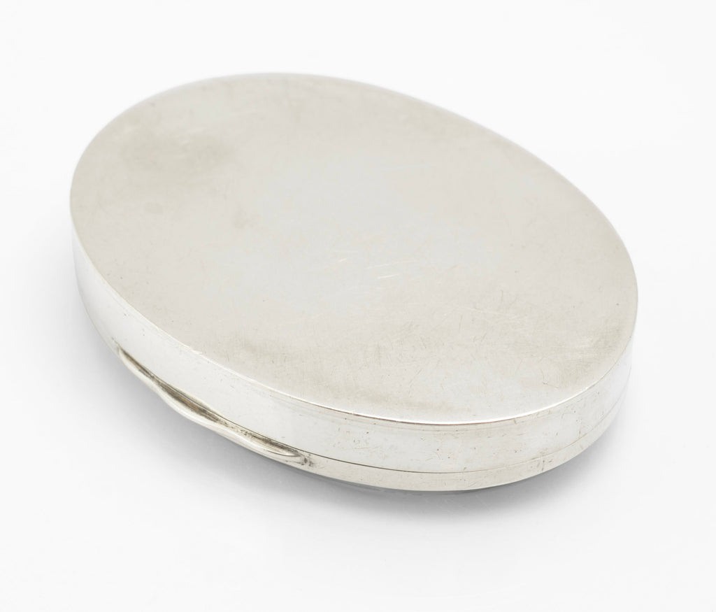 Antique sterling silver oval box shown from the hinge side with the moss agate cabochon lid closed