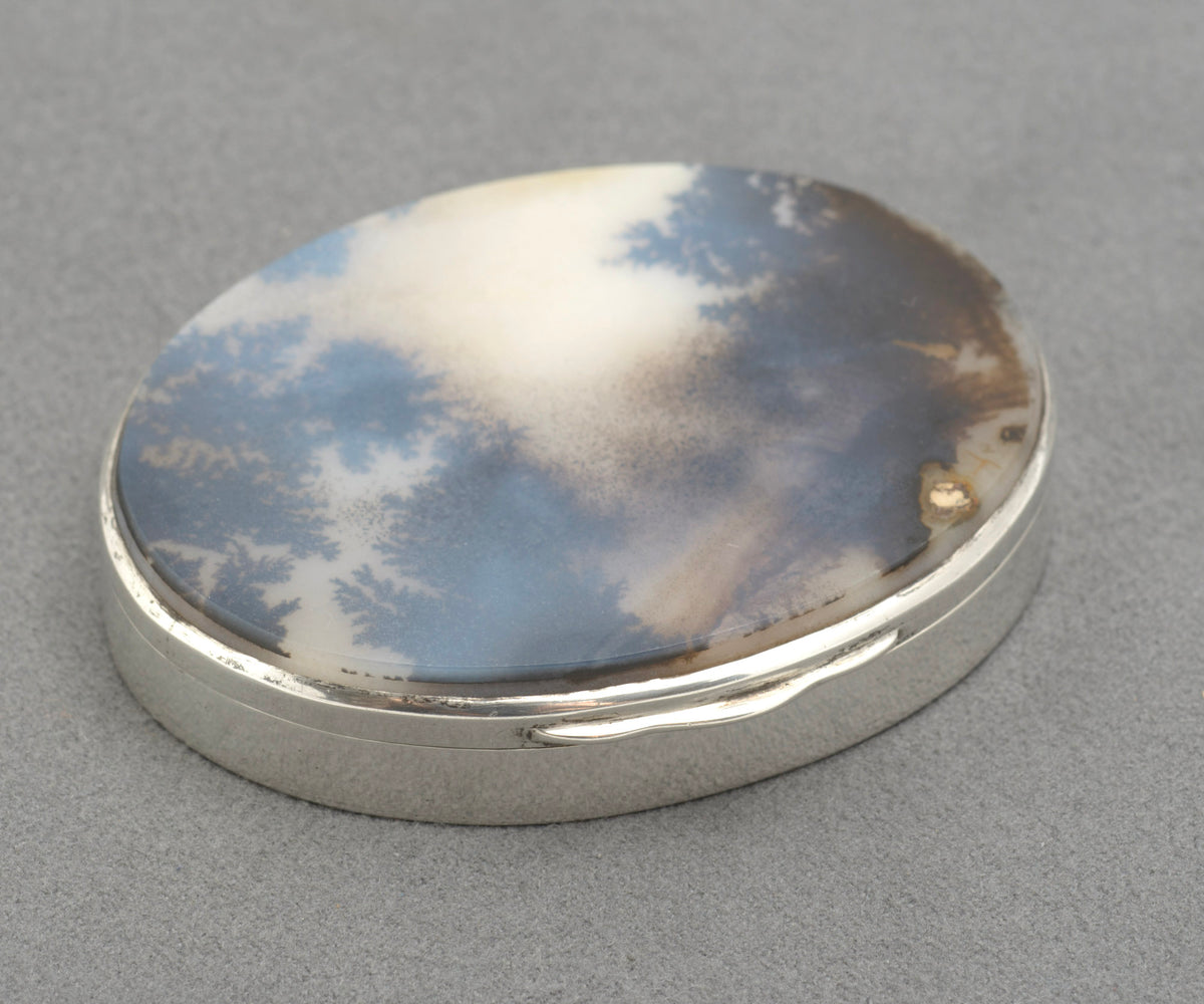 Top view of the natural moss agate cabochon set into the lid of an antique sterling silver oval box