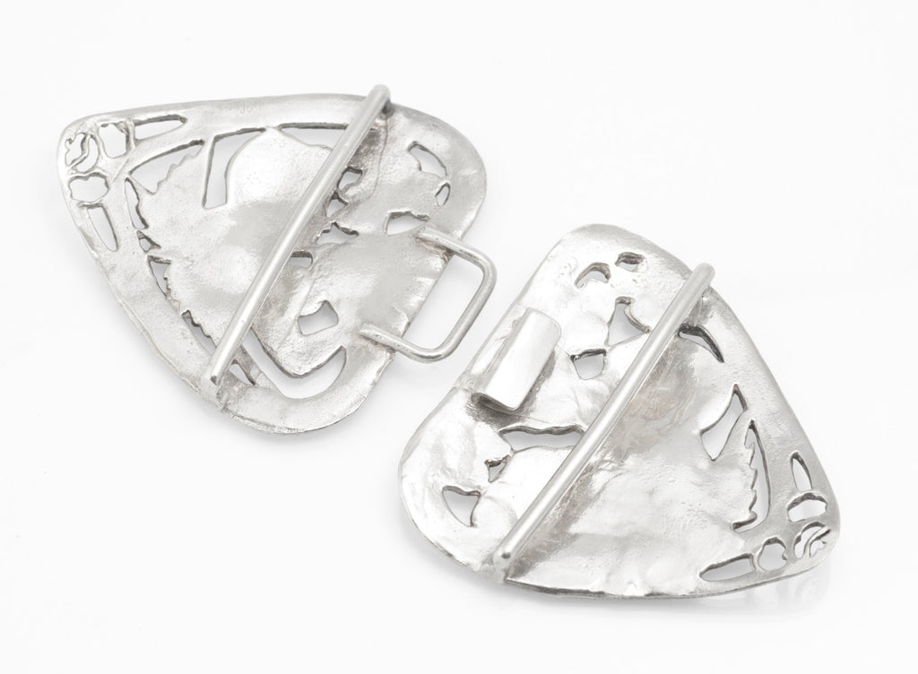 Angled front view of the two pierced sterling silver nurses belt buckle sections with winged figures