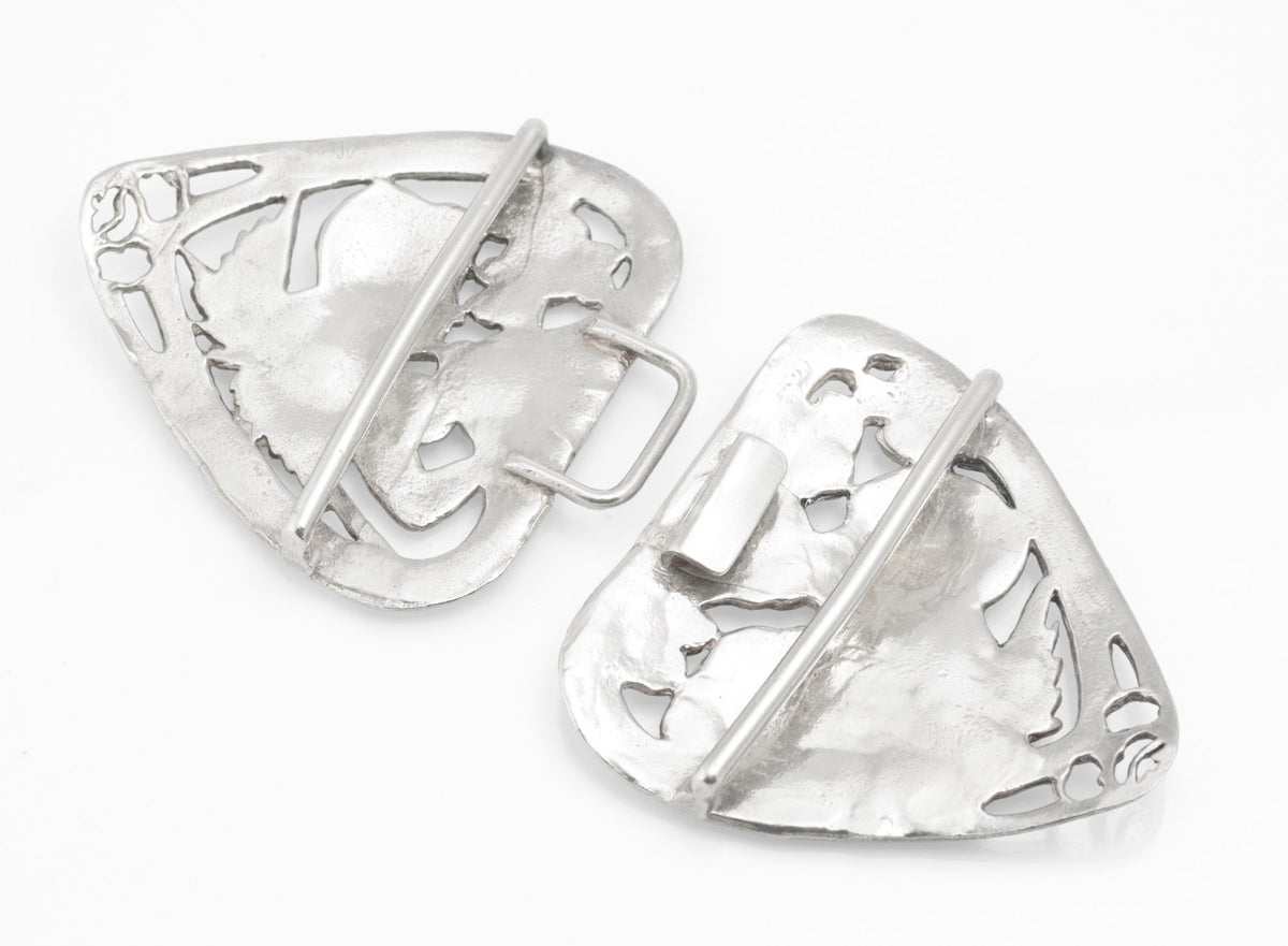 Angled front view of the two pierced sterling silver nurses belt buckle sections with winged figures