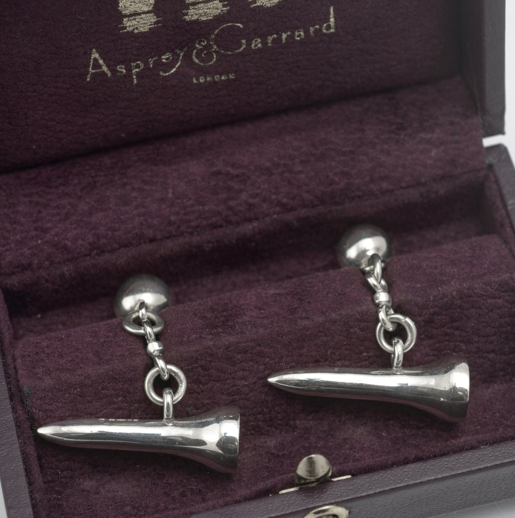 Vintage Asprey and Garrard sterling silver golf tee cufflinks displayed outside the original fitted box