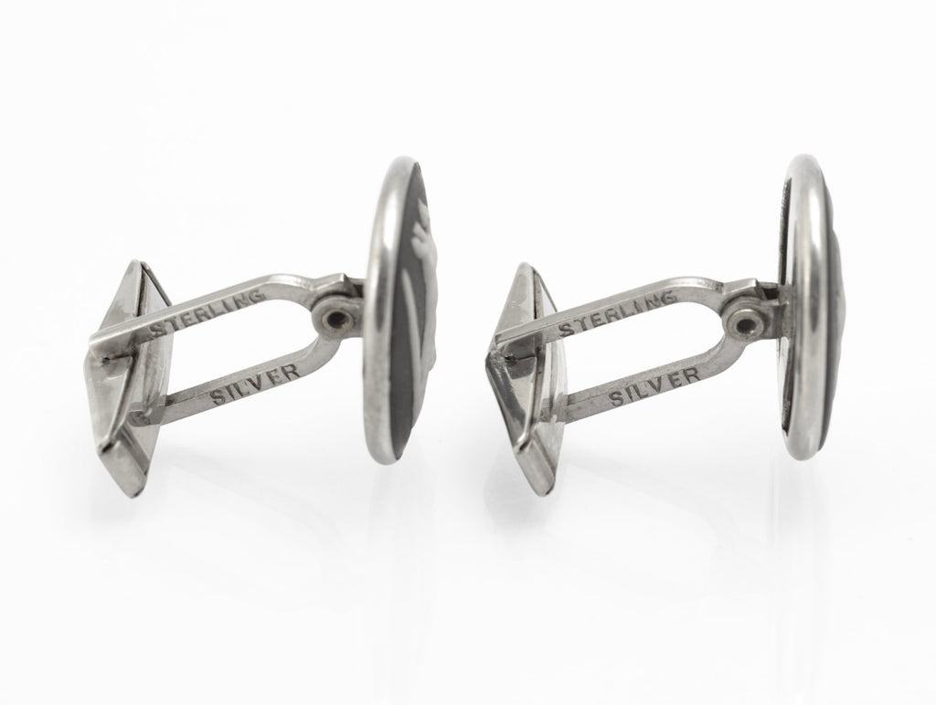 Close front view of vintage Wedgwood black jasperware horse cufflinks with white relief designs after George Stubbs