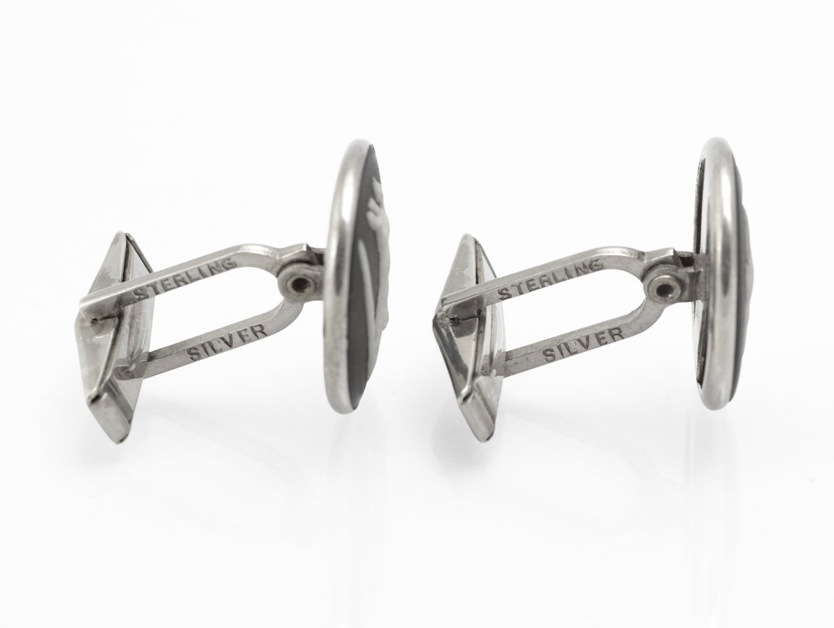 Close front view of vintage Wedgwood black jasperware horse cufflinks with white relief designs after George Stubbs