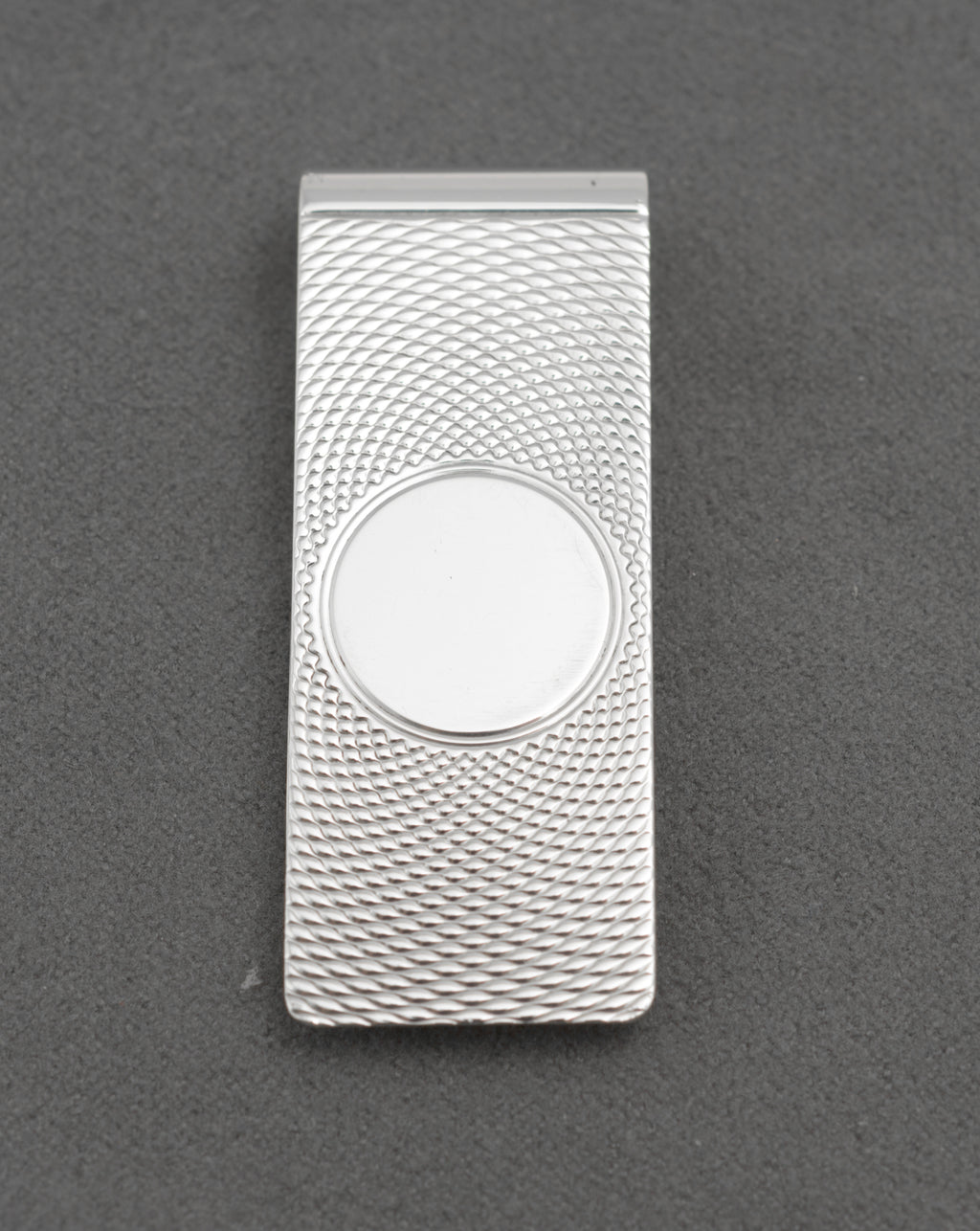 Angled front view of vintage William Manton sterling silver money clip with engine turned decoration