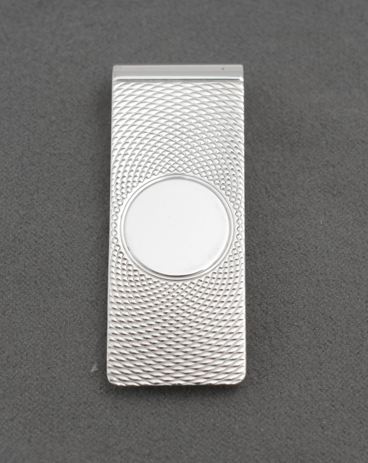 Angled front view of vintage William Manton sterling silver money clip with engine turned decoration