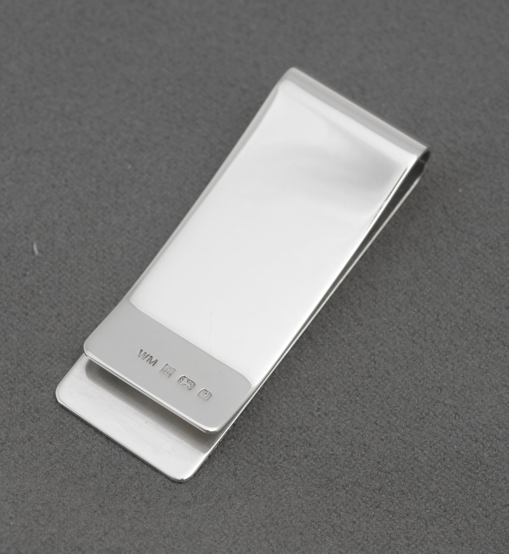 Reverse view of vintage William Manton sterling silver money clip showing the hallmark and plain polished silver
