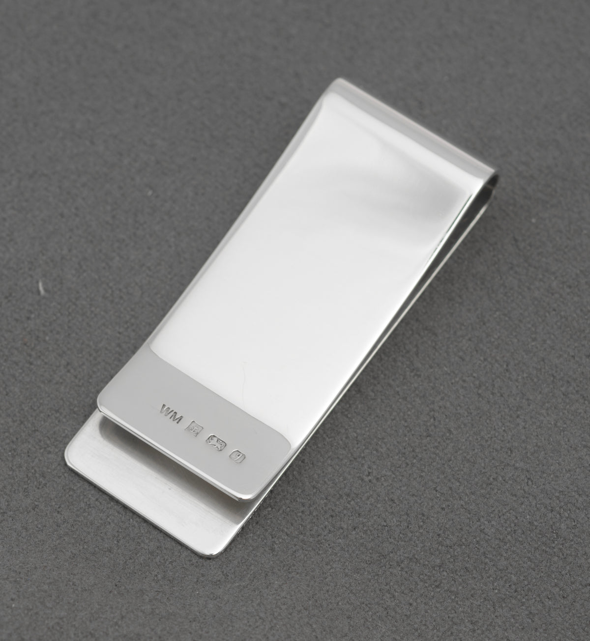 Reverse view of vintage William Manton sterling silver money clip showing the hallmark and plain polished silver