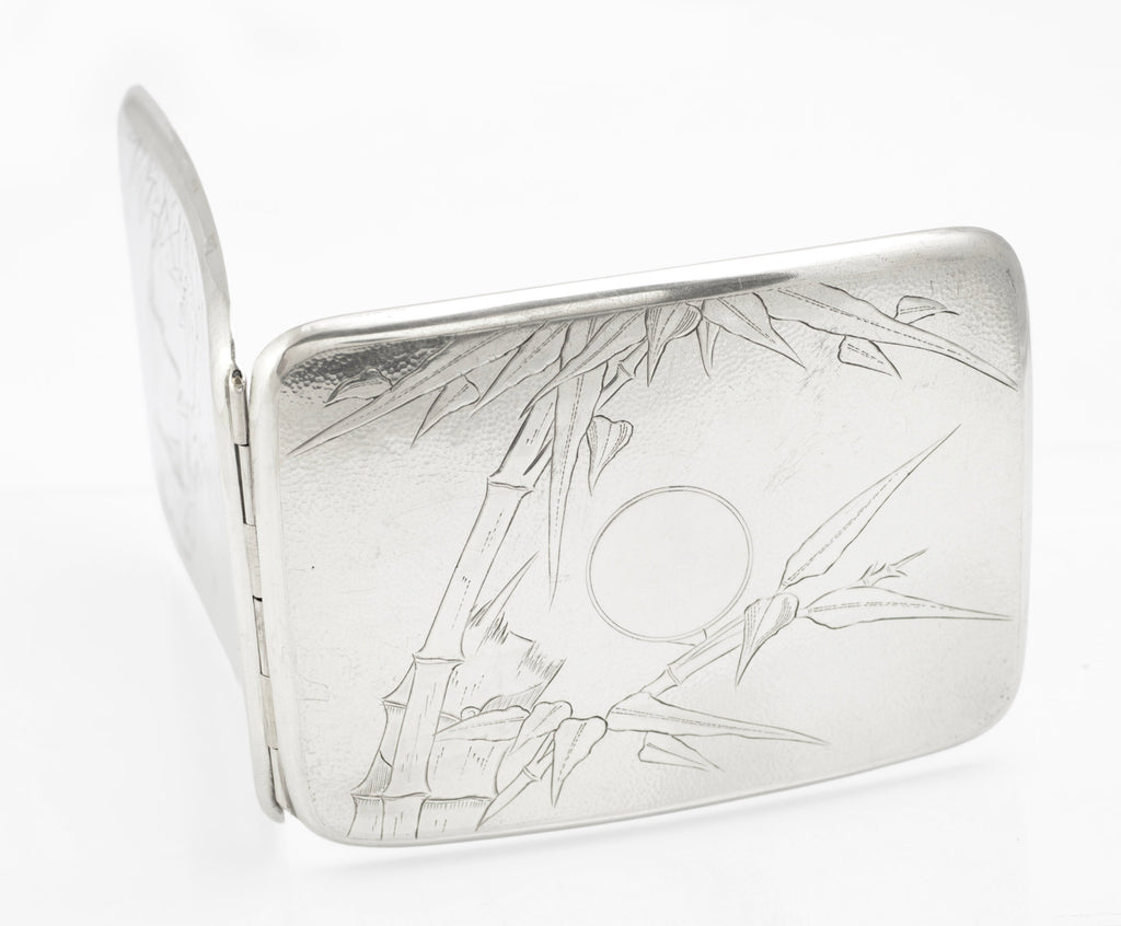 Interior of an antique Chinese export sterling silver cigarette case showing gilt wash and spring wire retaining straps