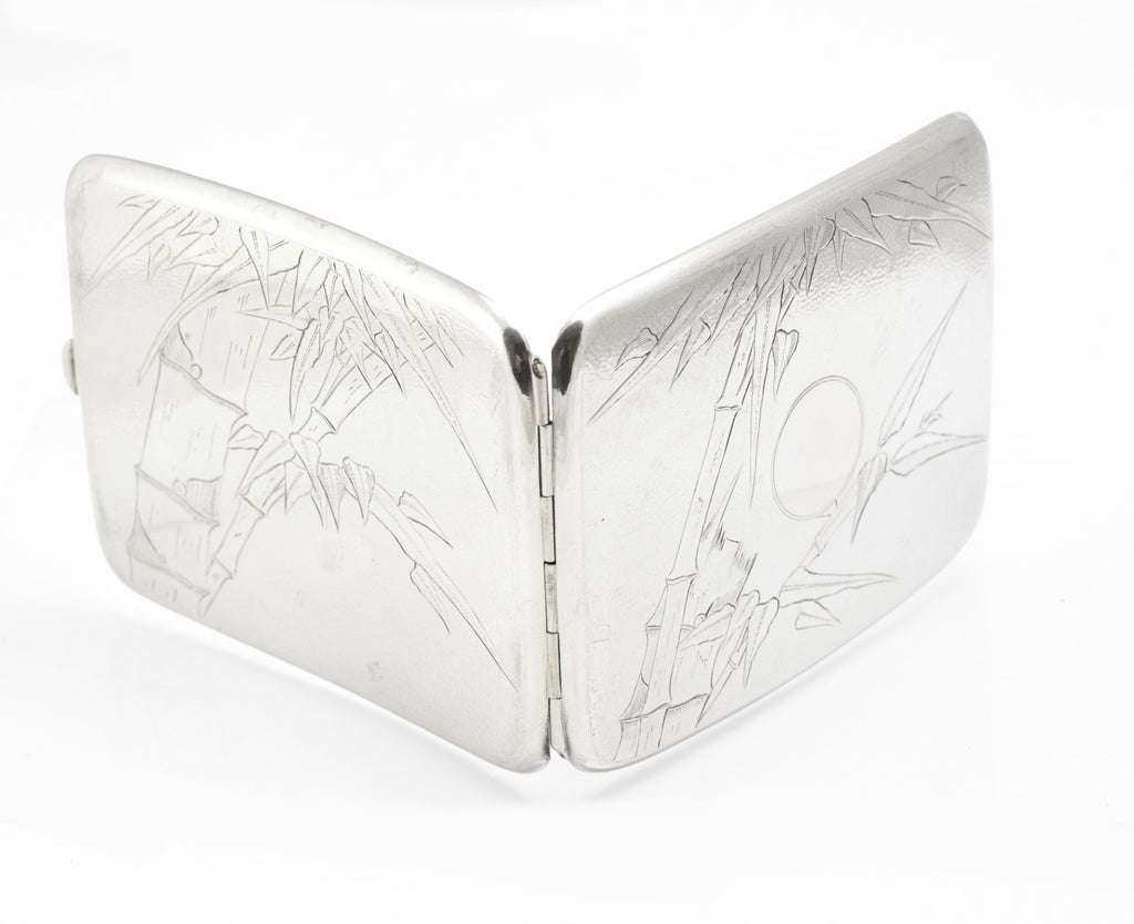 Open interior view of an antique Chinese export sterling silver cigarette case with gilt washed halves