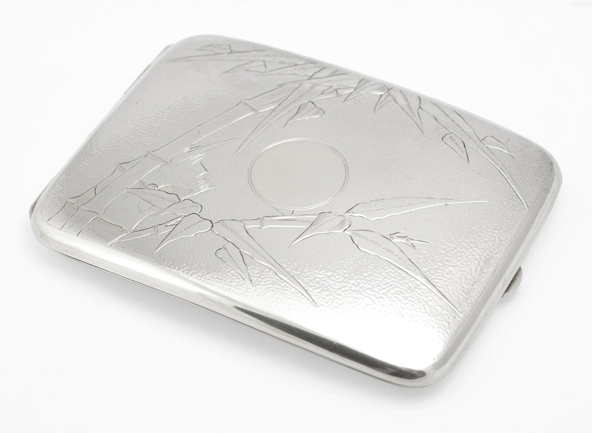 Antique Chinese export sterling silver cigarette case shown closed at an angle with gently curved profile