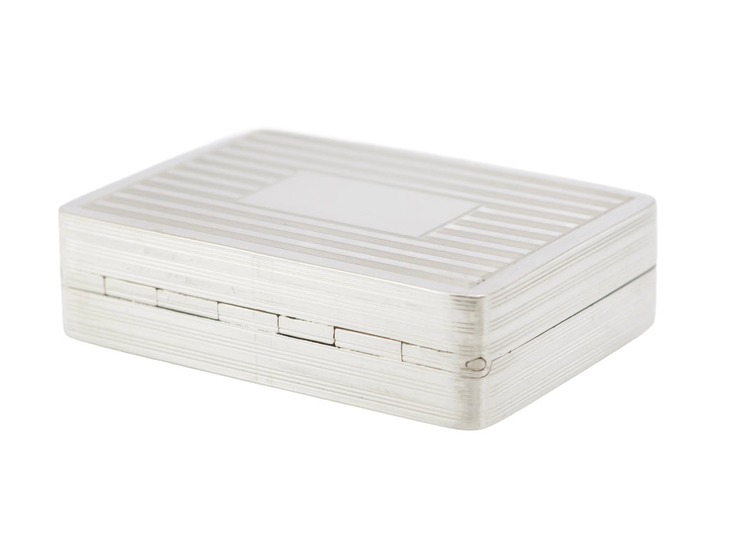 Front view of vintage sterling silver pill or snuff box showing the closely fitted lid and rear hinge line