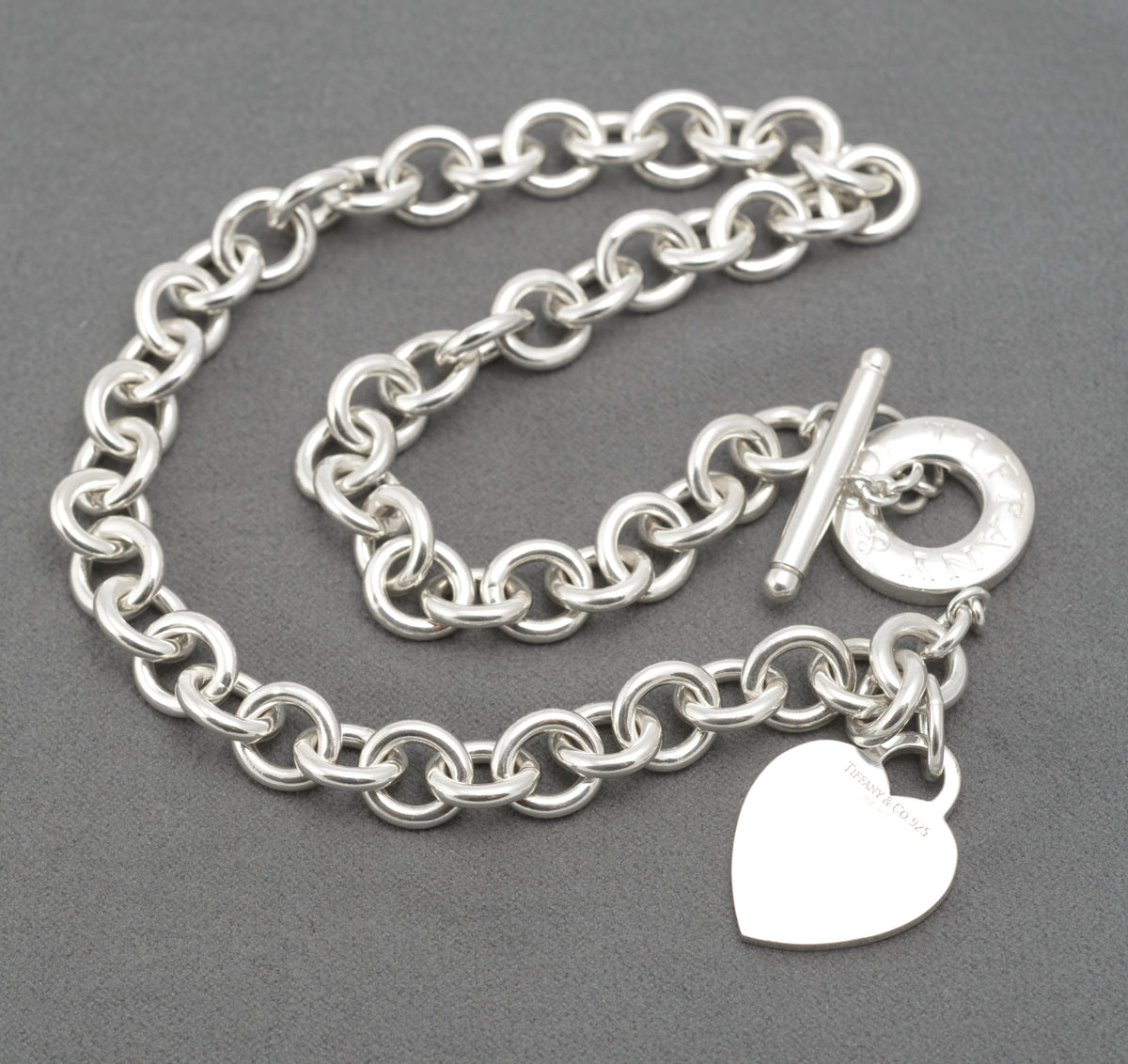 Full view of vintage Tiffany and Co sterling silver Heart Tag necklace showing the T bar and toggle disc fastening
