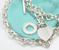 Vintage Tiffany and Co sterling silver Heart Tag necklace arranged on a grey background showing the full chain