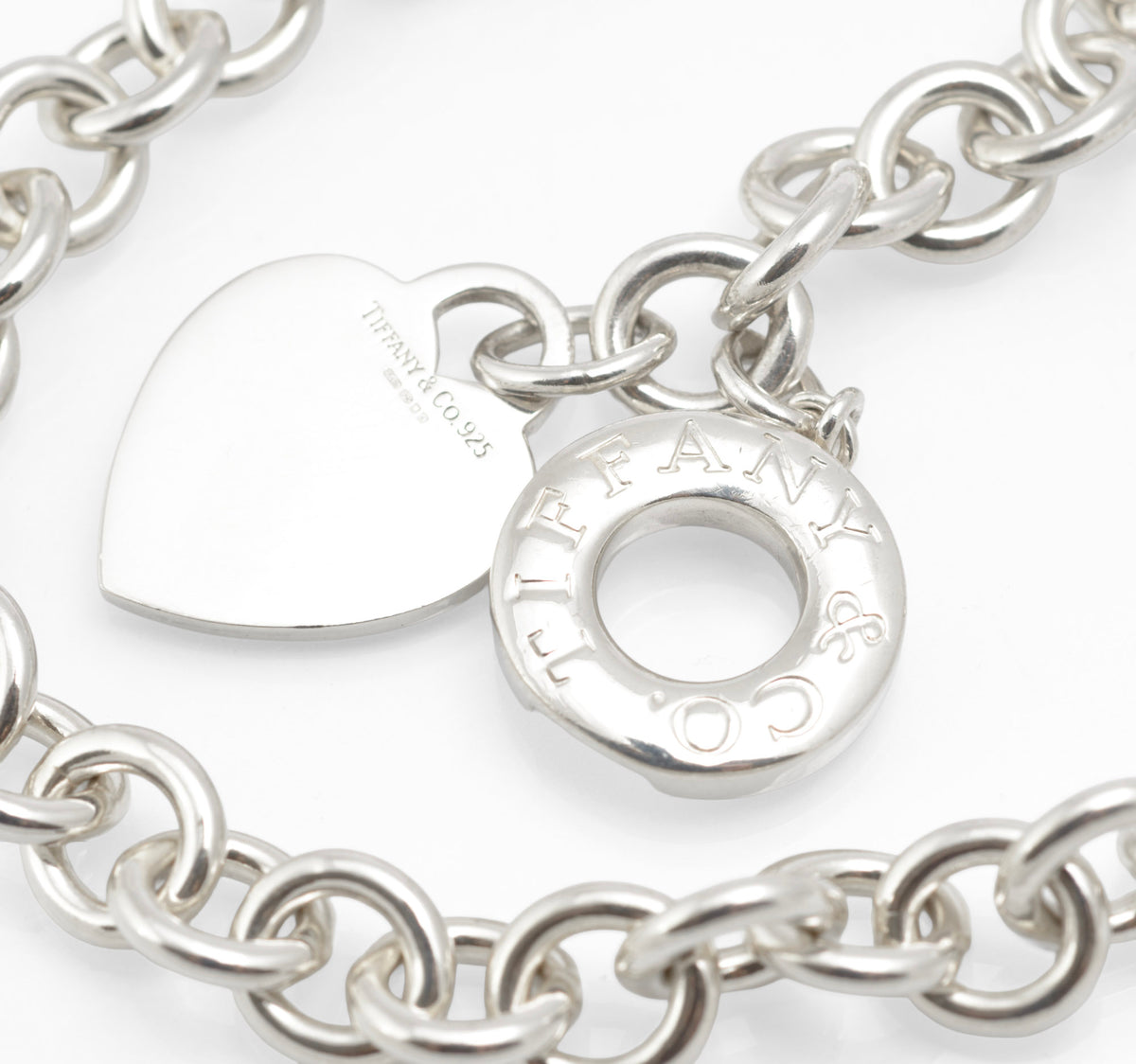 Close view of the Tiffany sterling silver heart tag and toggle fastening with Tiffany pouch lettering