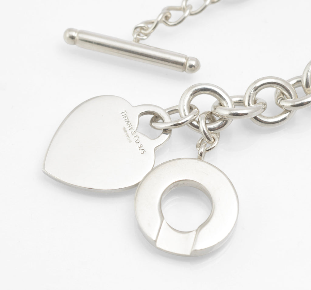 Close view of the circular Tiffany and Co sterling silver toggle disc and heart tag