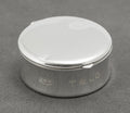 Closed front view of vintage Tiffany & Co sterling silver 1837 circular pill box with concave profile