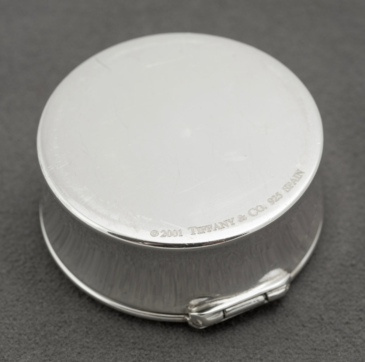 Detail of the Tiffany & Co 1837 marks on the side of the sterling silver circular pill box