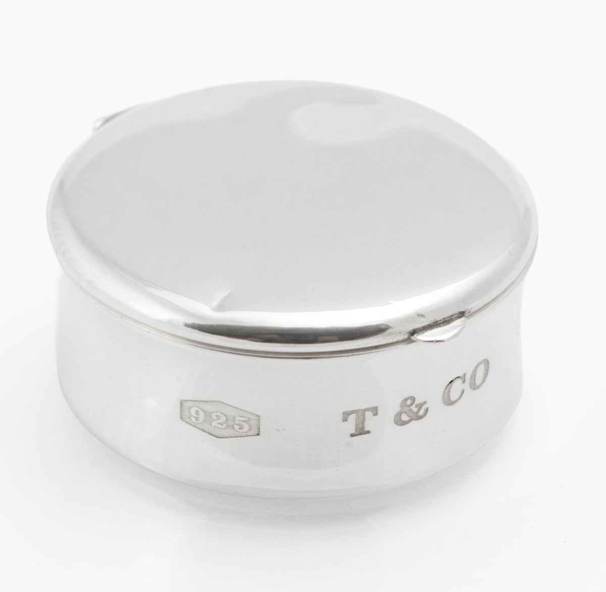 Underside view of Tiffany & Co sterling silver pill box showing the © 2001 Tiffany & Co 925 Spain engraving