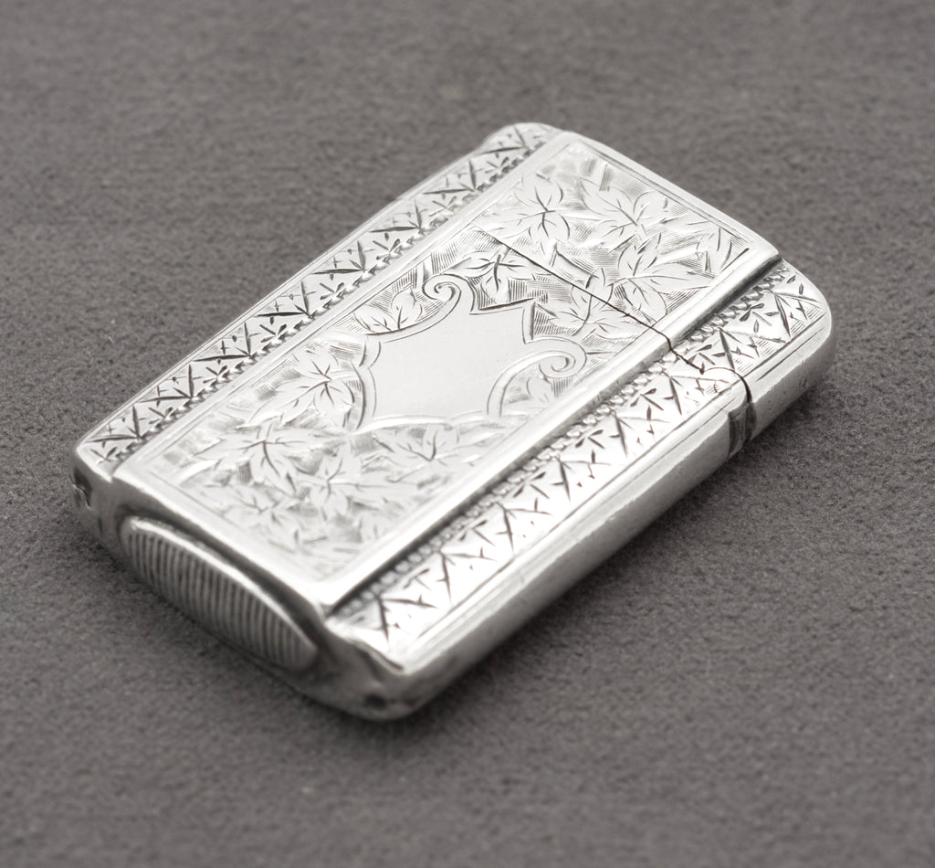 Closed Victorian sterling silver vesta case with rounded corners and detailed foliate engraving