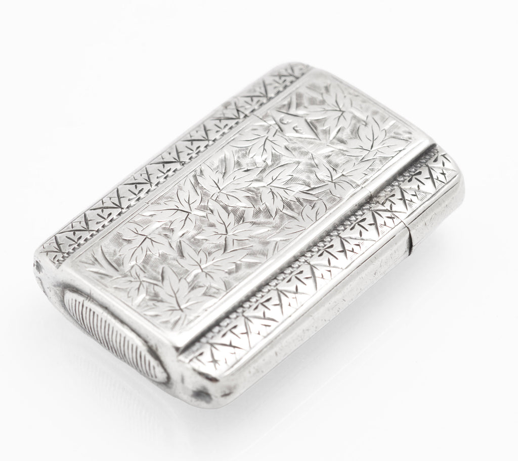 Top view of the antique Victorian sterling silver vesta case showing the raised central panel and engraved borders
