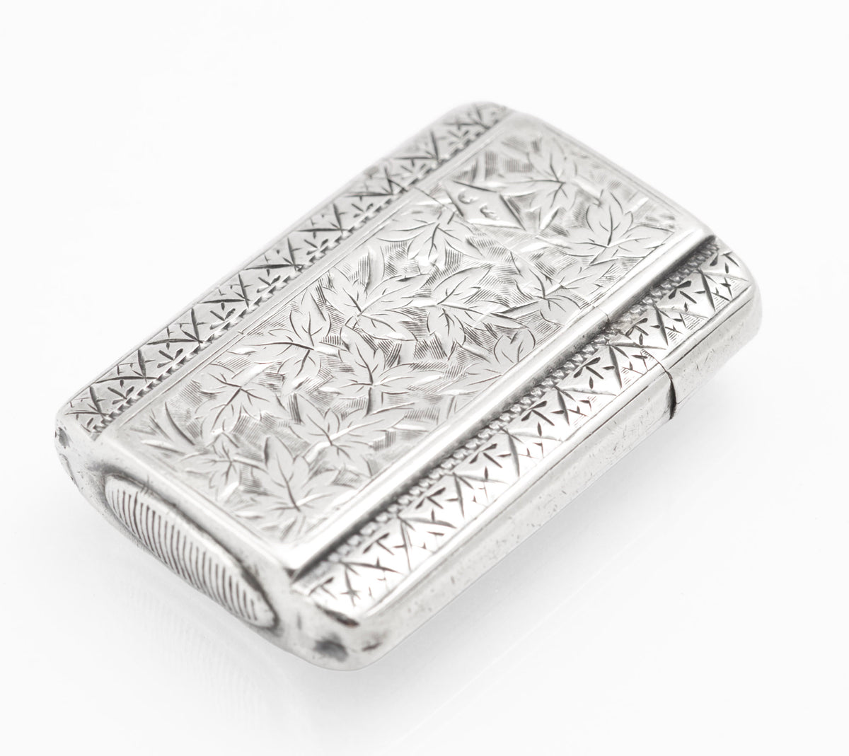 Top view of the antique Victorian sterling silver vesta case showing the raised central panel and engraved borders