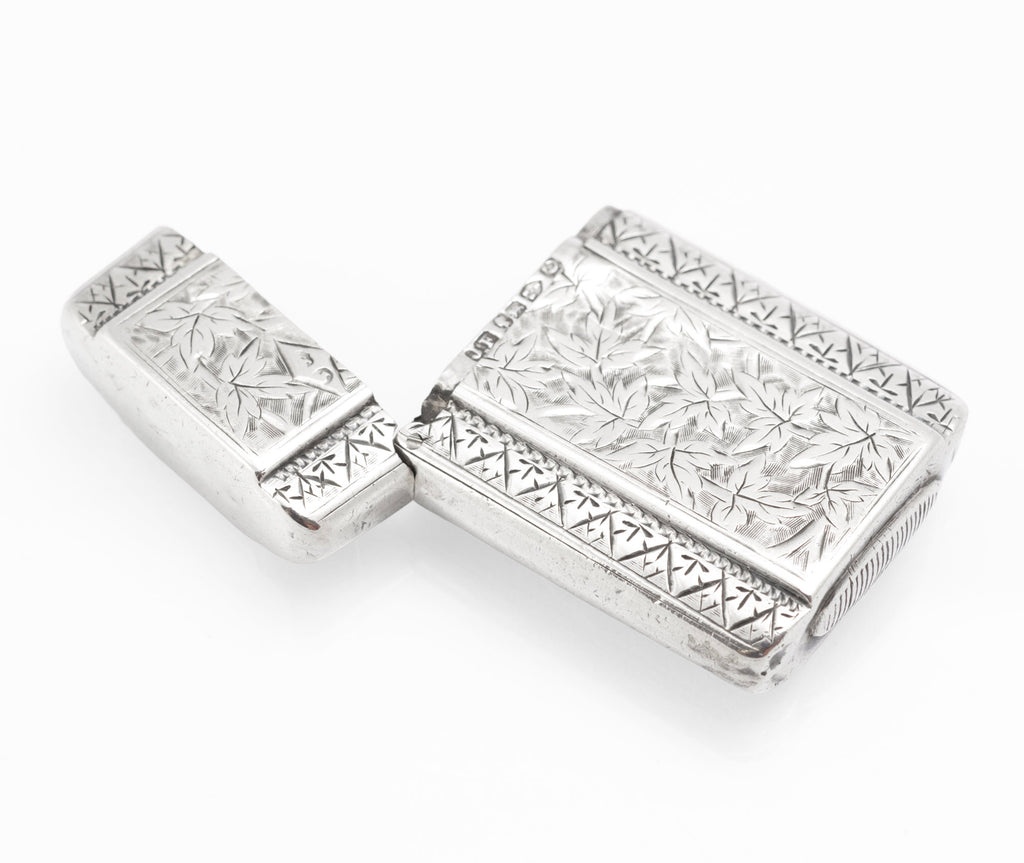 Side view of the open Victorian sterling silver vesta case with its engraved borders