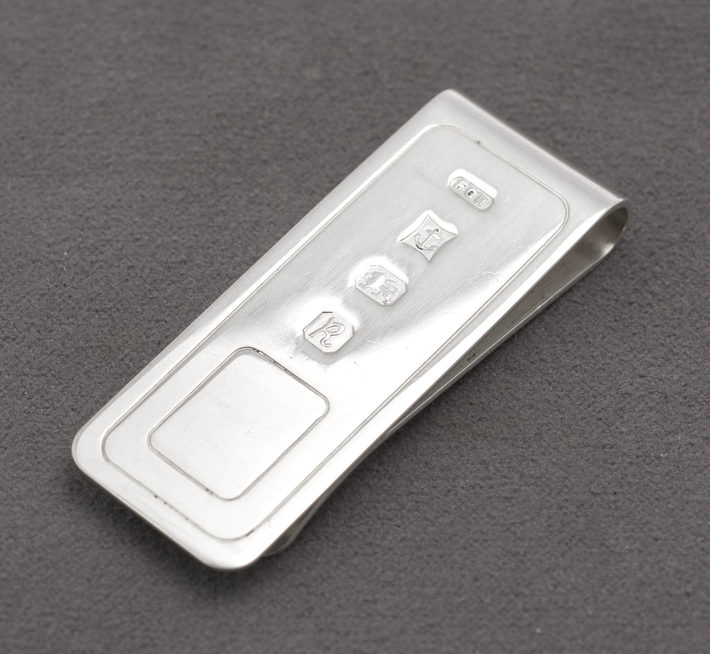 Vintage sterling silver money clip by Harrison Brothers and Howson Ltd showing the Birmingham hallmarks and maker's mark FGH