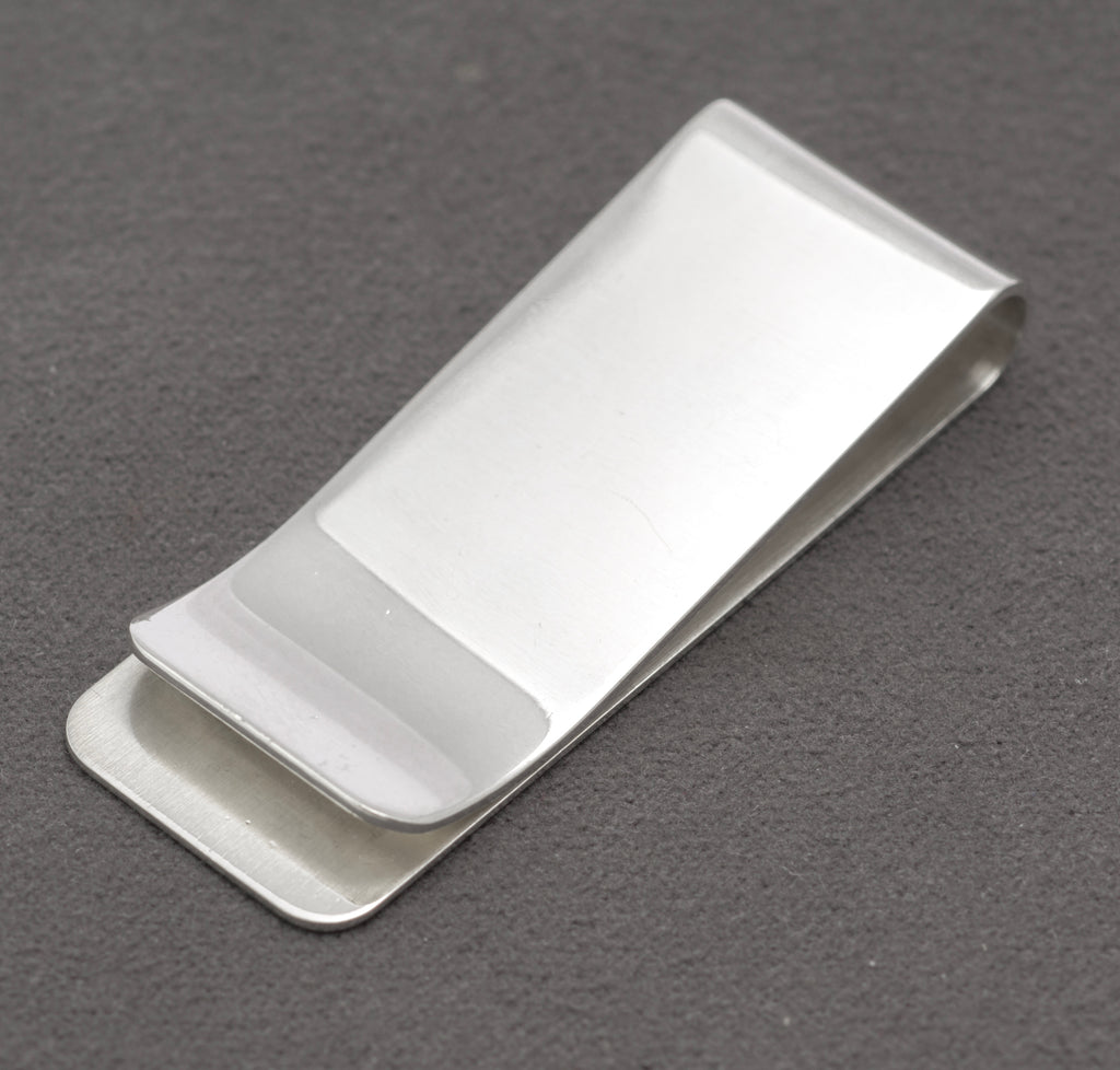 Close view of the FGH maker's mark, Birmingham anchor, lion passant and 1991 date mark on the silver money clip