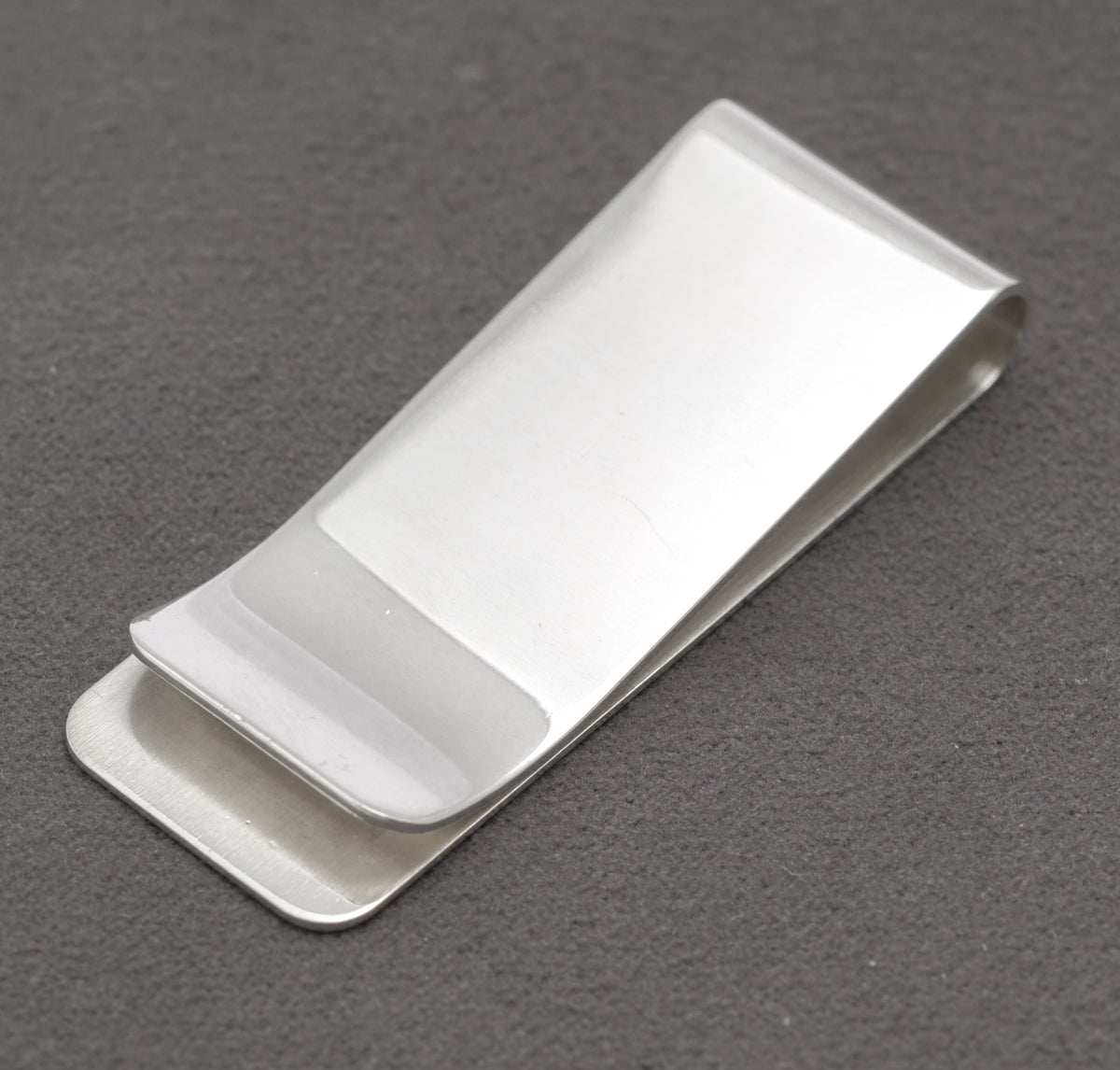 Close view of the FGH maker's mark, Birmingham anchor, lion passant and 1991 date mark on the silver money clip