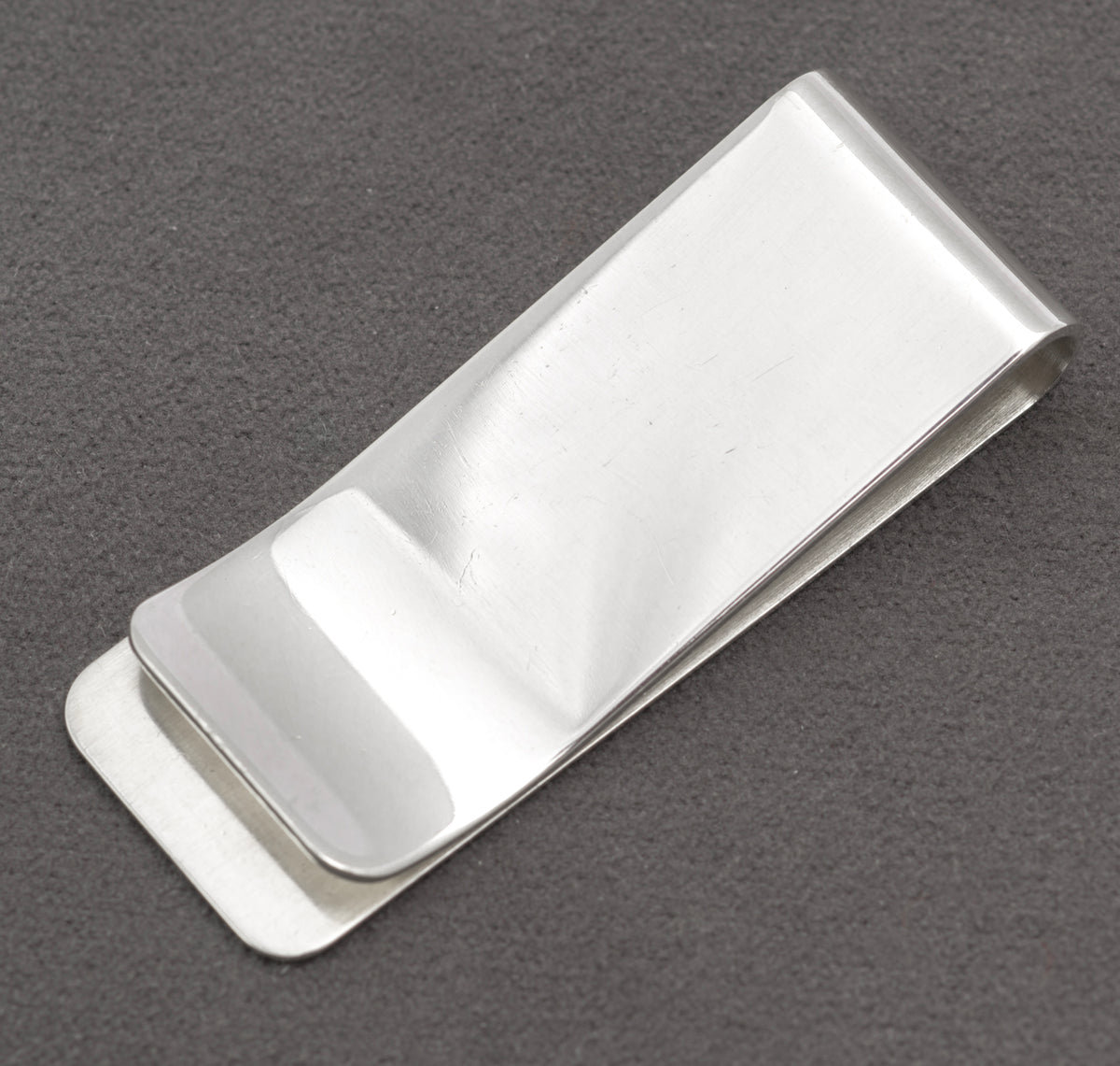 Front view of vintage sterling silver money clip with broad polished face and softly rounded corners