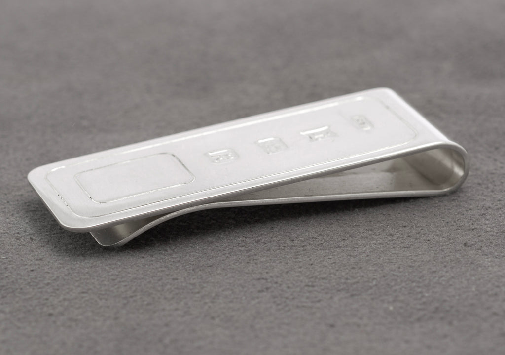 Side profile showing the curved spring form of the vintage sterling silver money clip