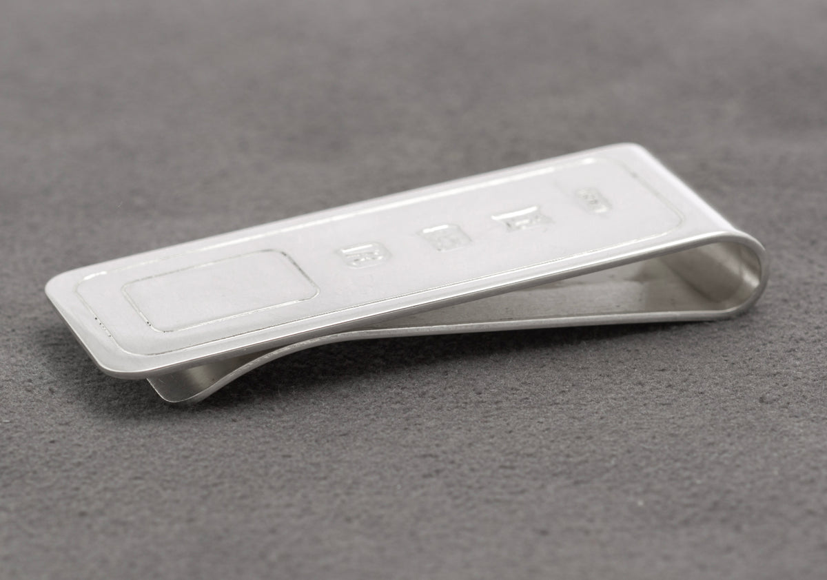 Side profile showing the curved spring form of the vintage sterling silver money clip