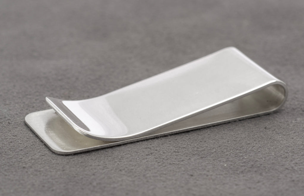 Open side view showing the spring tension and folded construction of the sterling silver money clip