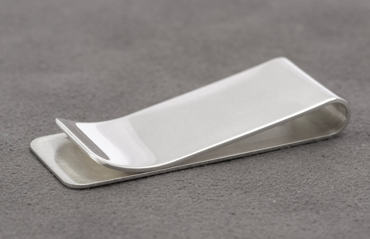 Open side view showing the spring tension and folded construction of the sterling silver money clip