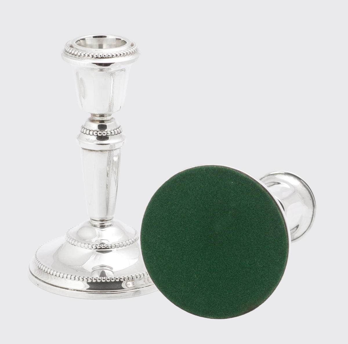 Front view of the matching sterling silver candlesticks showing tapering stems and cup shaped nozzles