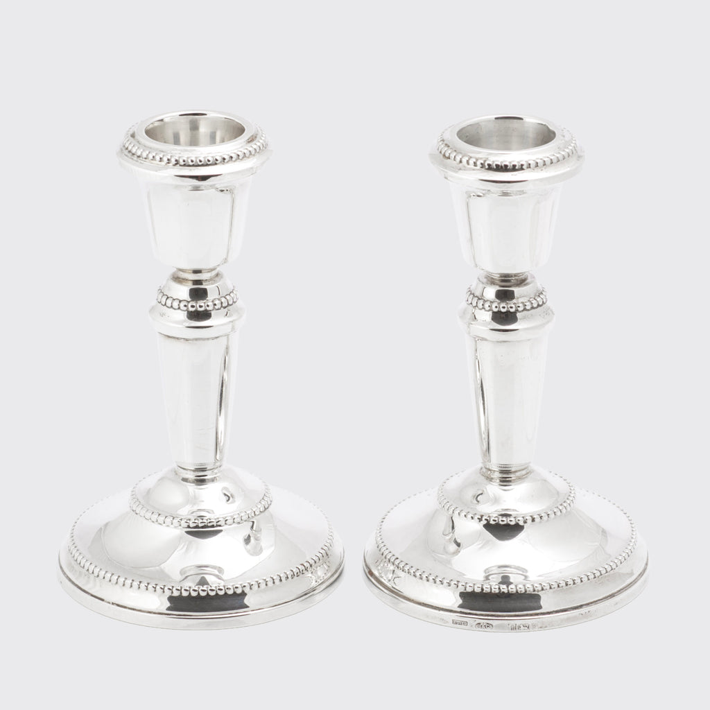 Decorative view of the vintage sterling silver candlesticks showing beaded base and nozzle borders