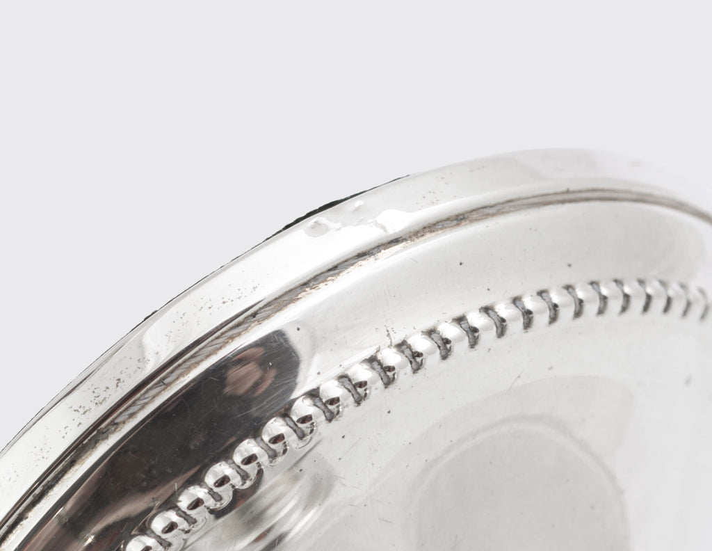 Close view of the beaded detailing around the bases, stems and candle nozzles of the silver candlesticks