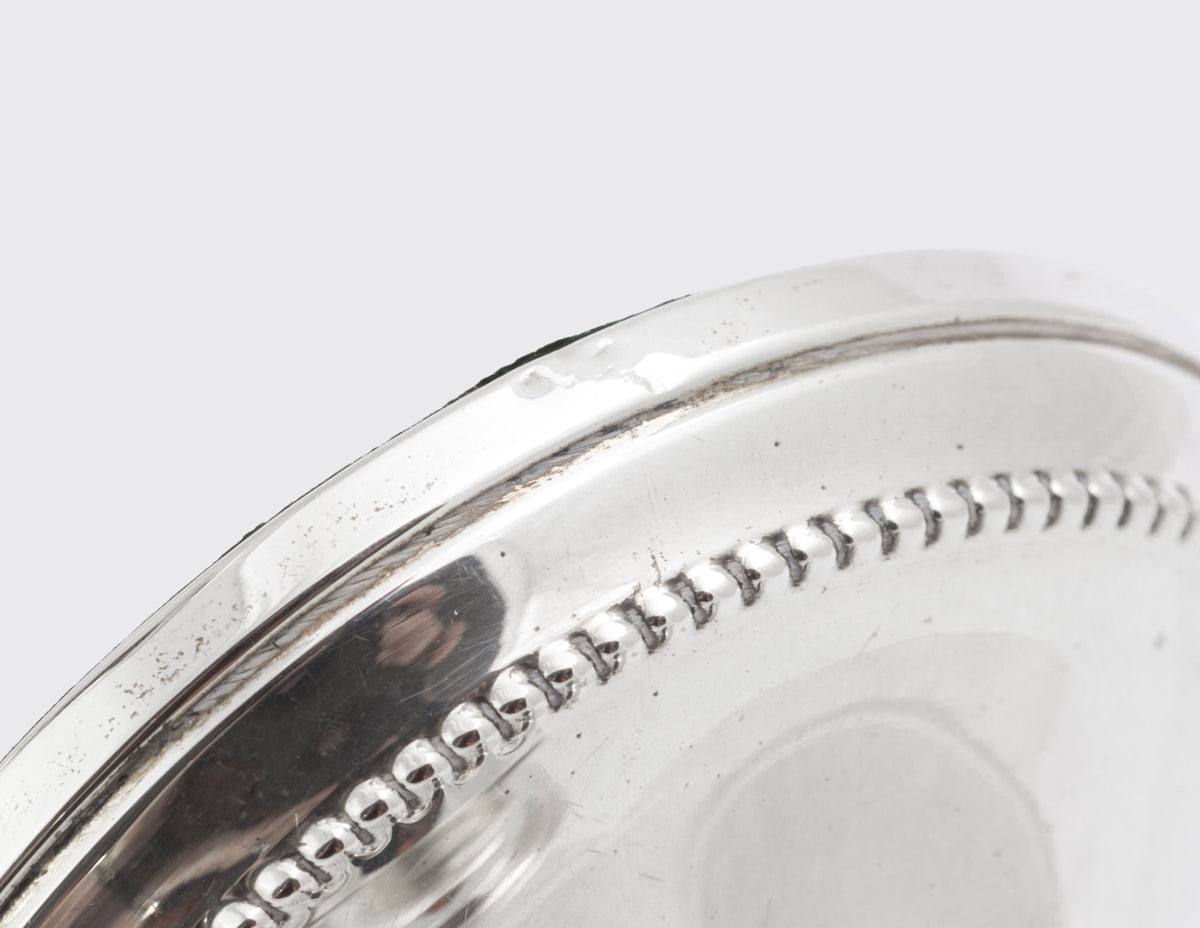Close view of the beaded detailing around the bases, stems and candle nozzles of the silver candlesticks