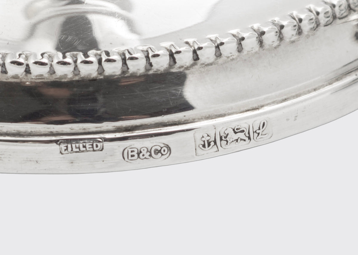 Close view of the hallmark and beaded border on one vintage sterling silver candlestick