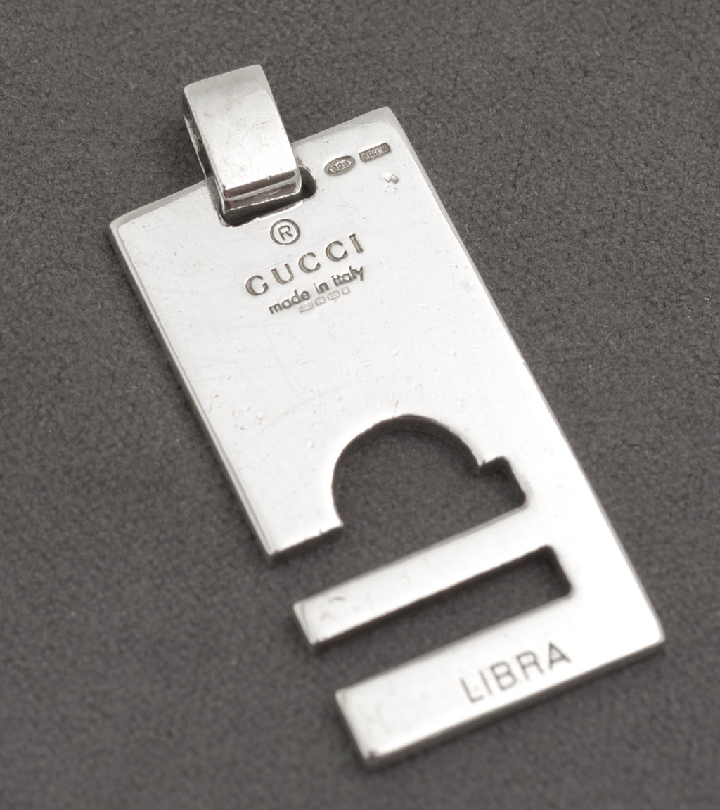 Plain polished side of Gucci silver pendant with cut through Libra symbol - C3110