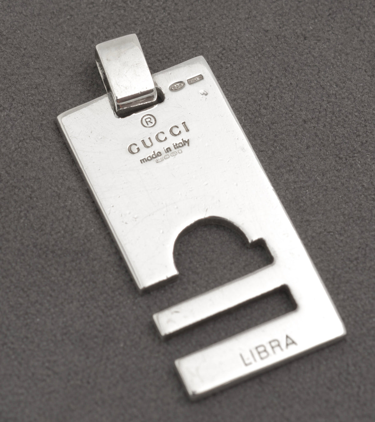 Plain polished side of Gucci silver pendant with cut through Libra symbol - C3110